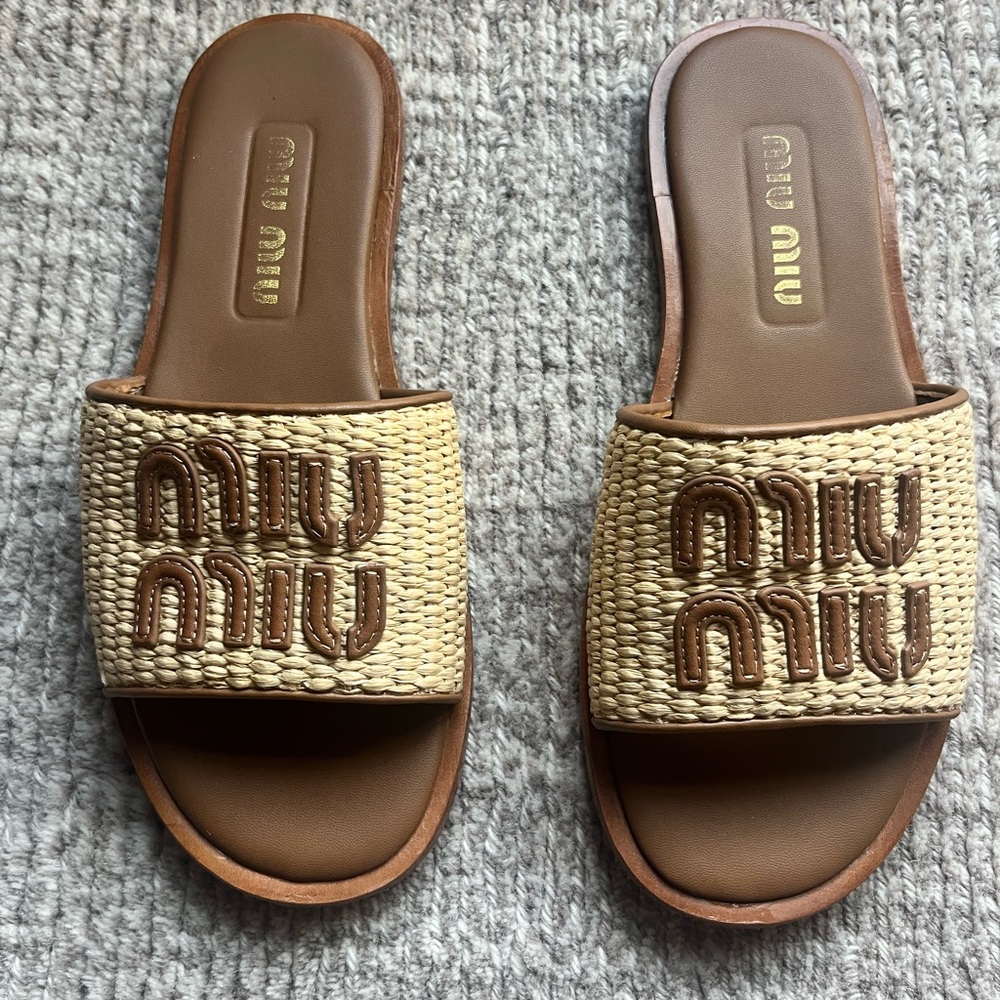 Crafted of ultra-luxe raffia, Miu Miu slides
